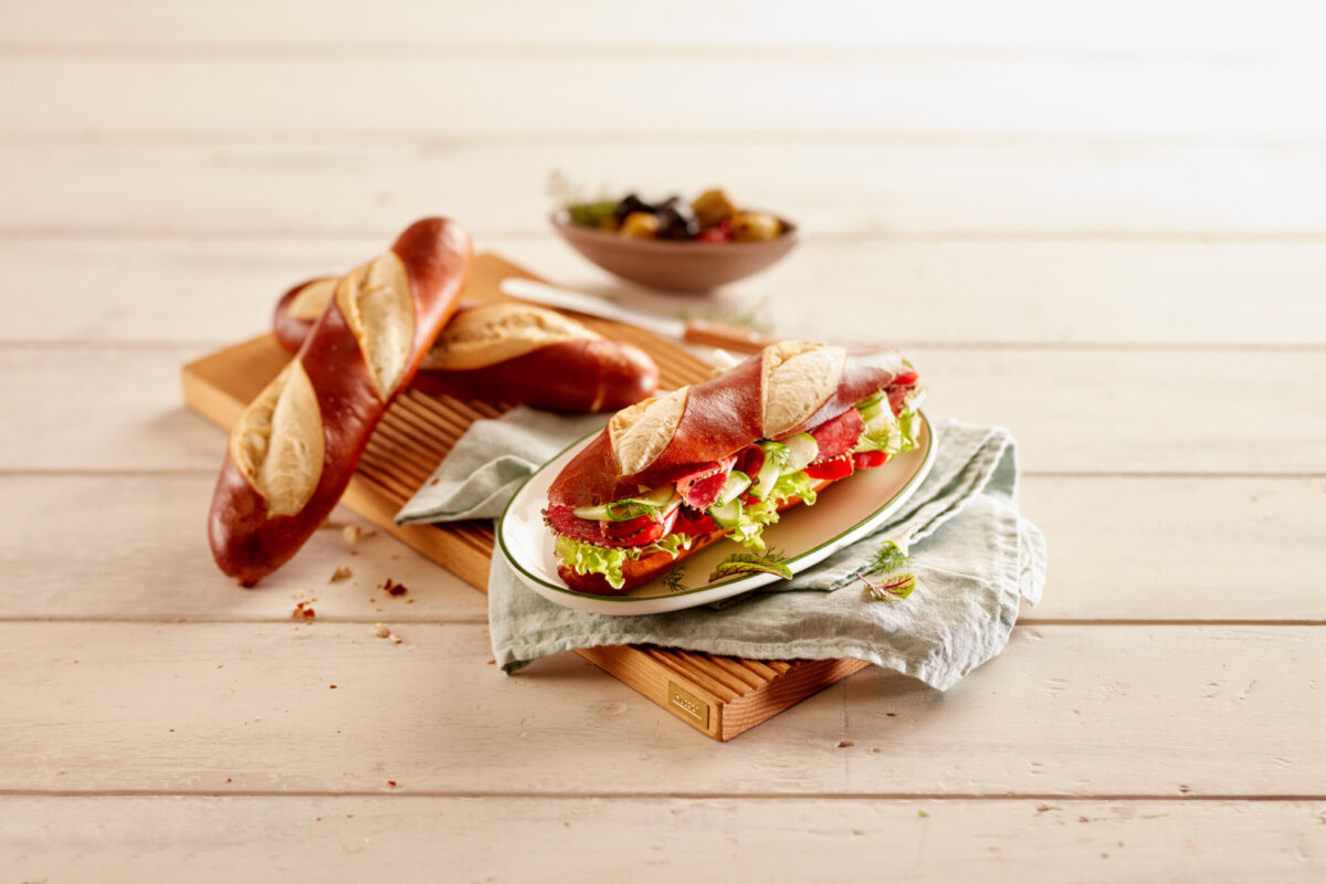 Picture of Pretzel Baguette on plate Filled with Lettuce and Salami